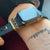 gold gold stainless Apple Watch with black sport band and bytten Monaco stack accessory - gold